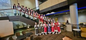 (English) The whole group in nošnja posed on the hotel's staircase and in the lobby.